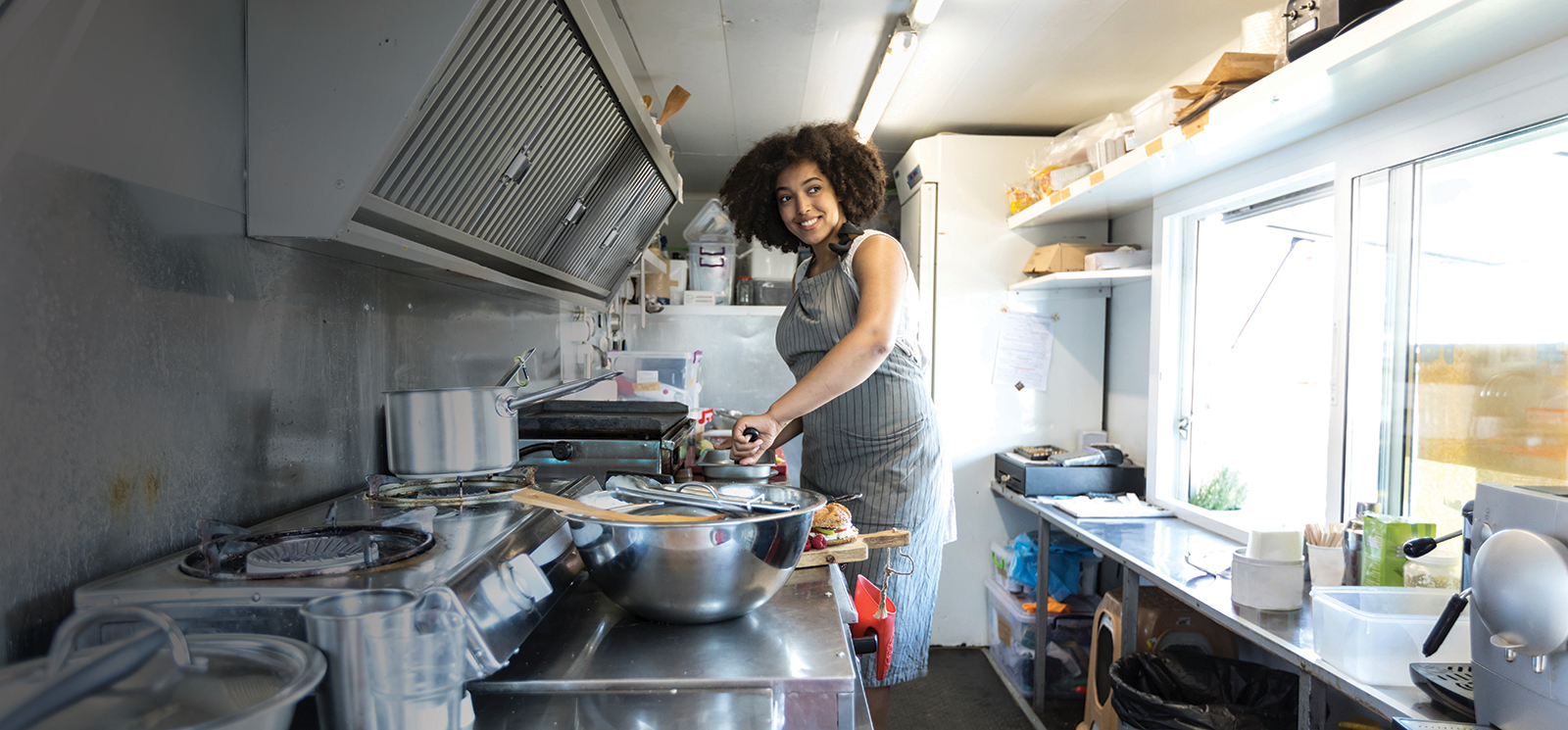 IMAGE: Woman cooking inside food truck