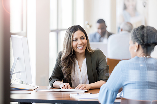 IMAGE: Mortgage loan officer giving advice to homebuyer