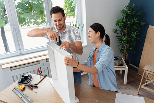 IMAGE: Couple building shelves inside kitchen