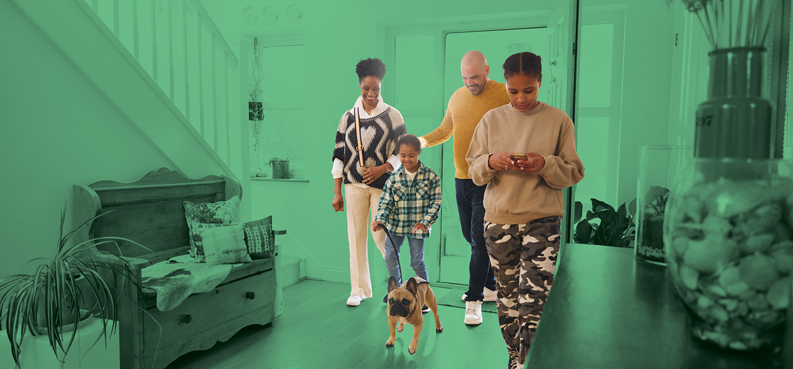 IMAGE: Family walking into house with green background