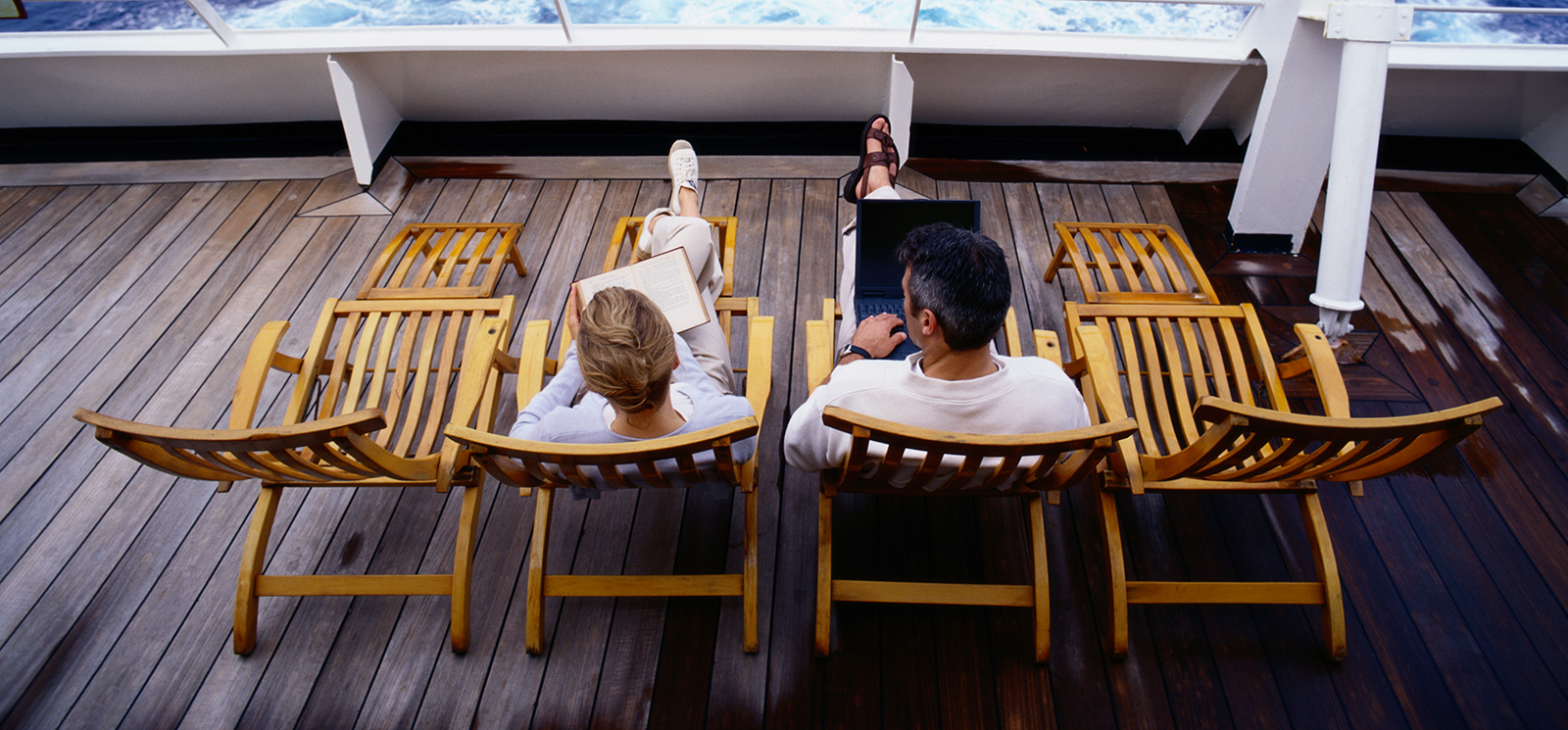 IMAGE: Couple sitting in deck chairs on cruise ship