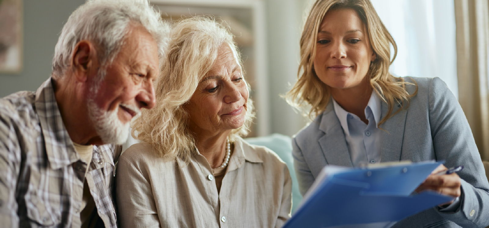 IMAGE: Couple looking over documents with an advisor