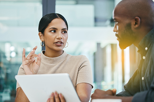 IMAGE: Man and woman talking about business inside office