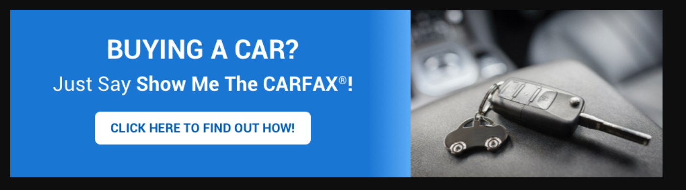 IMAGE: car keys with car keychain inside vehicle with text Buying a car? Just Say Show Me The Carfax! Click here to find out how!