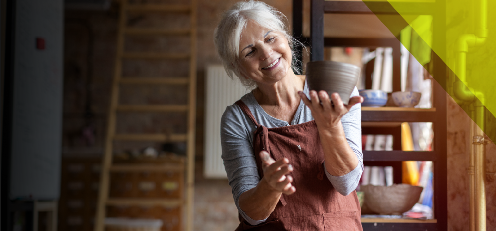 IMAGE: Woman smiling holding pottery